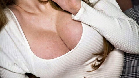 Lenina Crowne in deep cleavage white sweater, seductive pose
