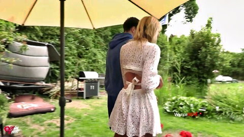 Blonde MILF Miley-Weasel in lace dress with young guy outdoors