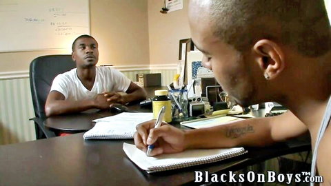 Two muscular black men in tank tops at office desk in BlacksOnBoys gay porn scene