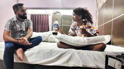 Desi couple chatting casually on bed before steamy action