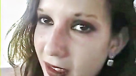 Seductive brunette with glossy parted lips and smoky eyes teasing closeup.