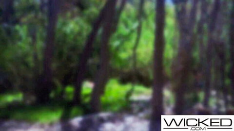 Blurry lush green forest woods backdrop for wild outdoor fucking on Wicked.com