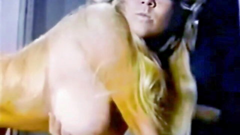 Blonde babe with massive natural tits lying nude on side exposing huge breasts