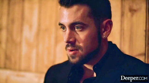 Intense closeup of handsome bearded man in black shirt staring seductively