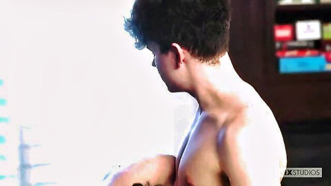 Skinny young brunette gay guy posing shirtless in profile view showing toned body
