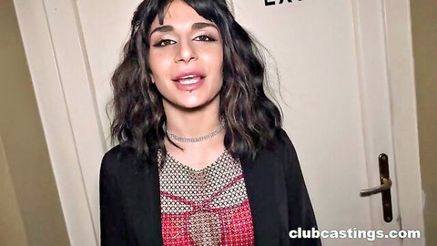 Lola Danger smiling seductively in black blazer and red top at club casting