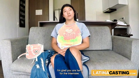 Latina woman in casual t-shirt and jeans sits for casting interview
