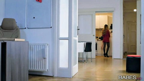 Blonde in red top black skirt stockings high heels teasing in kitchen from office
