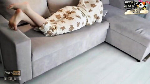 Step-sister in cute bear pajamas lounging barefoot on couch, teasing tight ass for anal