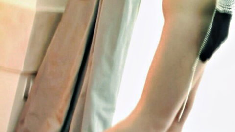 Closeup of shaved pussy stretched wide by thick black dildo in torn fishnet stockings