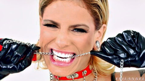 Blonde MILF in black latex gloves bites chain from red spiked collar smiling seductively