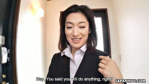 Seductive Japanese office boss in suit smiles saying 'you'll do anything right' teasing employee