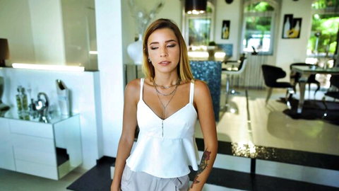 Skinny young Latina with medium tits showing deep cleavage in low-cut white top