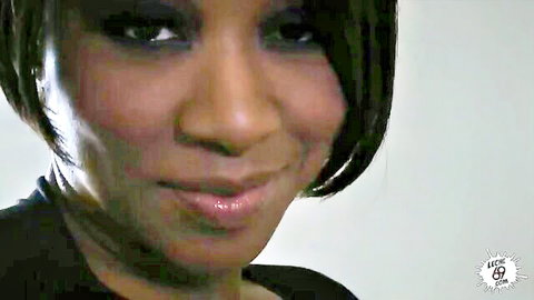 Stunning ebony babe with glossy lips and sultry smile in close-up