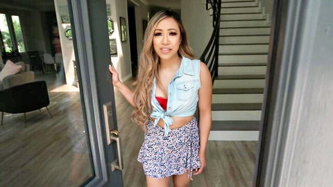 Slim Asian teen with small tits flashing red bra cleavage and tiny floral skirt in open doorway tease