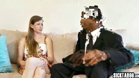 Lara Brookes sits with suited black stepdad on couch