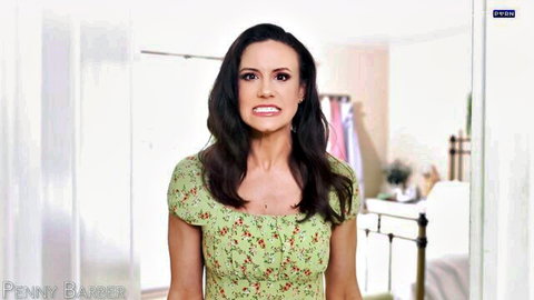 Brunette MILF grimacing in low-cut green floral dress with cleavage in bedroom