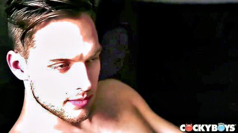 Handsome shirtless gay twink with stubble gazes seductively in CockyBoys promo