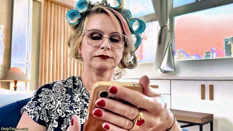 Tiffany with curlers and glasses checks phone in curvy MILF preview