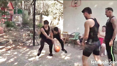 Fit basketball players in tight sportswear, mixed group outdoor action