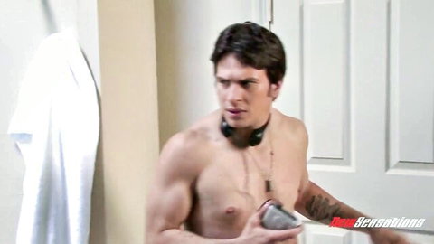 Rocco Reed shirtless muscular with collar holding toy in intense scene