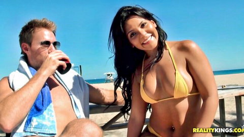 Rose Monroe in yellow bikini smiling on beach with Hunter, seductive charm