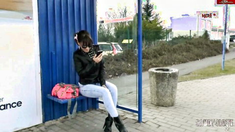 MILF Sandy4Love in leather jacket and tight jeans at outdoor bus stop POV tease