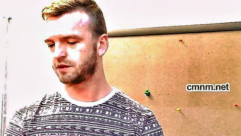 Blonde bearded man in striped shirt, intense gaze from passionate swinger video