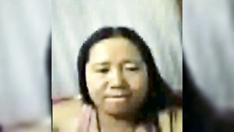 Mature Thai webcam MILF smiling seductively in tight pink tank top closeup