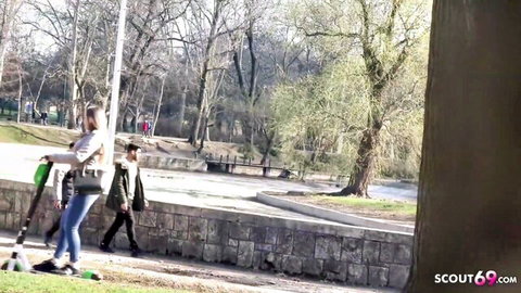 Blonde Lucie rides scooter in park as German scout approaches for pickup