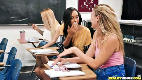 Three sexy schoolgirls laughing in sex ed classroom wearing tight tops and jeans