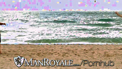 Two shirtless muscular gay hunks tossing frisbee on sunny beach