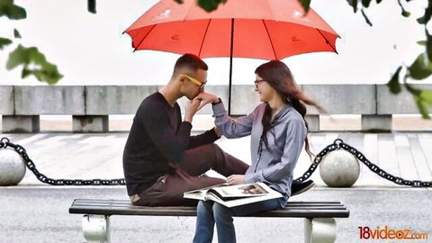 Skinny brunette with natural tits teases stud under red umbrella on rainy day