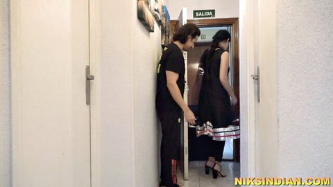 Niks Indian in sexy black dress and heels with stud in hallway