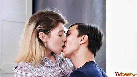 Blonde petite teen passionately kissing man in plaid shirt