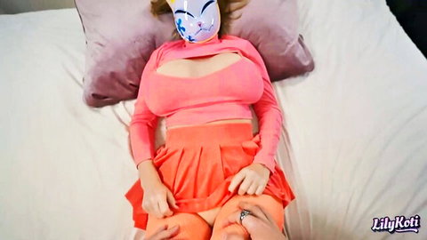 Big-titted Asian babe in pink crop top and cat mask, teasing with hiked skirt