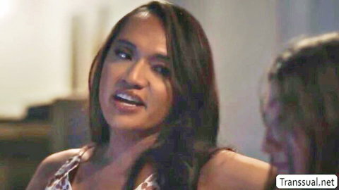 Brunette trans babe with long hair and medium tits showing deep cleavage in low-cut top