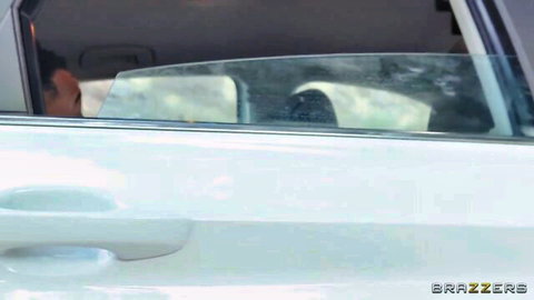 Man sitting in white SUV with open door in Brazzers car scene