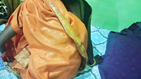 South Indian wife in orange sari sitting on floor showing tight ass curves