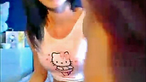 Slender Asian beauty in Hello Kitty top and thongs posing seductively