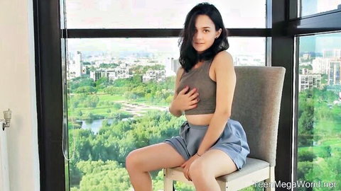 Naughty babe teases underboob in cropped top and shorts by city window view