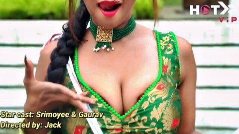 Seductive Indian MILF sticks tongue out showing huge tits cleavage in tight green blouse