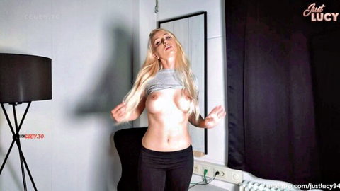 Blonde big tits babe Just Lucy dances topless exposing huge bare boobs in tight black leggings
