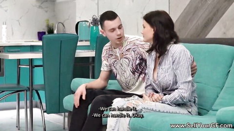 Busty brunette seducing her man with massive cleavage on couch