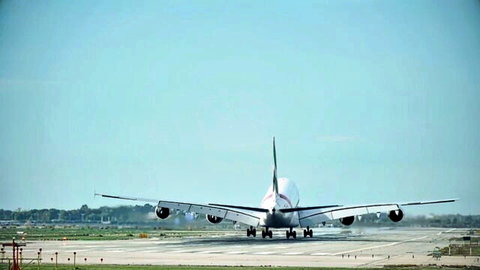 Airplane on runway at airport, clear skies, no models visible