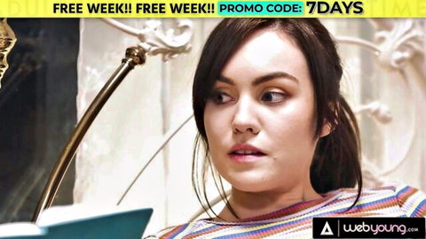 Brunette college girl in striped top looks surprised while studying intimate session