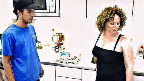 Curvy blonde MILF in tight black dress with big tits teases young guy in kitchen