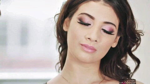 Brunette beauty with purple smoky eyeshadow and glossy pouty lips teasing seductively