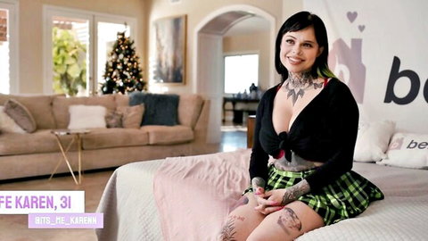 Tattooed Karen in short plaid skirt and cleavage-revealing cardigan