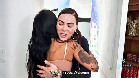 Curvy tattooed Latina brunette in sexy bra passionately hugged by girlfriend showing cleavage